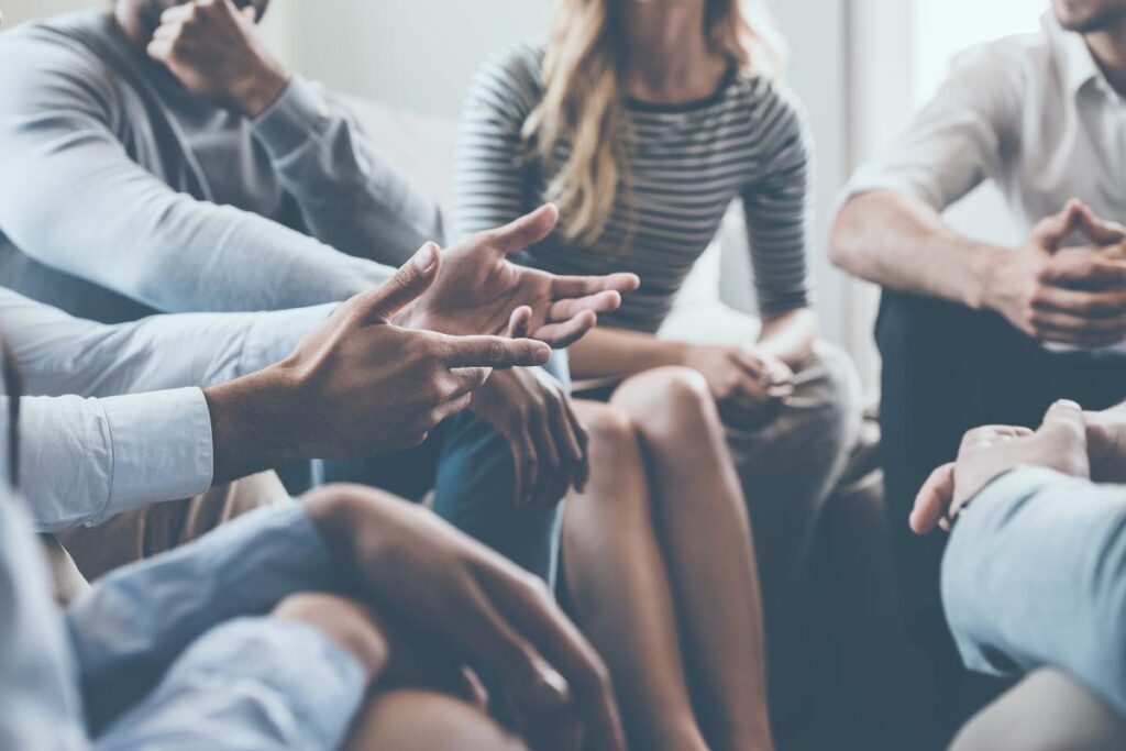 a woman participates in group therapy for bipolar disorder treatment