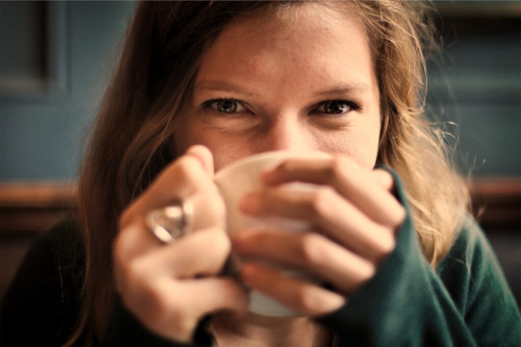 girl, woman, smile, smiling, happy, coffee, tea, cup, drinking, eyes, people, cozy, comfortable, relaxed, sipping, coffee cup, brown coffee, brown happy, tea cup, brown relax, brown tea, brown smile, brown eye, brown happiness, brown cup